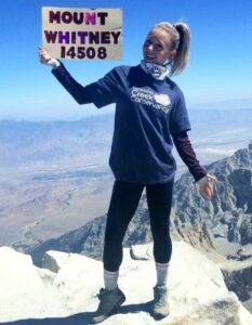 Rita stands atop Mount Whitney in 2019